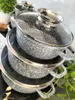 A stack of grey pots with a marble-ceramic coating and glass lids. Produktbild-Vorschau