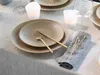 A table setting with plates, cutlery, and candles. Náhľad obrázku produktu