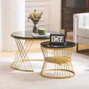 Two round coffee tables with black tops and gold metal bases are placed on a rug in a living room setting. Náhľad obrázku produktu
