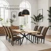 A dining room setting with a wooden table and chairs, illuminated by pendant lights. Náhled obrázku produktu
