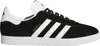 A side view of a black Adidas Gazelle sneaker with white stripes and sole. Produktbild-Vorschau