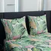 Two pillows and a duvet cover with a tropical leaf pattern are laid out on a bed. Náhľad obrázku produktu