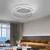 A modern living room with a large window overlooking the sea, a brown sofa, and a contemporary ceiling light. Produktbild-Vorschau
