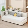 A beige daybed with white bedding and decorative pillows in a well-lit room.