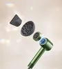 An exploded view of a green hairdryer with its attachments, set against a light, neutral background with subtle light refractions. Voir les images du produit