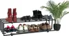 A black metal shoe rack with multiple shelves holding various shoes and a potted plant on the side. Náhled obrázku produktu