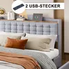 A bed with a headboard featuring a shelf and integrated USB ports, with bedding and decorative pillows. Produktbild-Vorschau