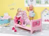 Two dolls in a child's bedroom with a pink doll bed. Produktbild-Vorschau