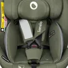 Close-up of a green car seat with safety harness and labels. Produktbild-Vorschau