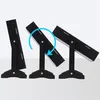Three black jewelry boxes shown at different angles to demonstrate adjustability, with a blue arrow indicating rotation. Produktbild-Vorschau