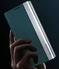 A hand holding a teal and silver phone case against a dark background. Produktbild-Vorschau