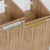A split image showing two identical wooden bathroom cabinets with different handle finishes. Anteprima dell’immagine prodotto