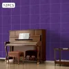 A piano and stool are placed in front of a purple tiled wall. Náhled obrázku produktu