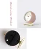 A pink alarm clock with a gold stand is shown from the front and the back. Produktbild-Vorschau