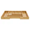 An empty bamboo cutlery organizer with multiple compartments, shown from a slightly elevated front-facing angle.