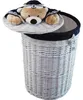 A white wicker laundry basket with a lid decorated with a plush teddy bear wearing a sailor outfit. Anteprima dell’immagine prodotto