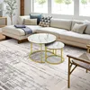 A modern living room with a sectional sofa, coffee tables, and a rug. Náhled obrázku produktu