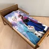 A child's bed with a duvet cover featuring characters from Disney's Frozen. Produktbild-Vorschau
