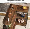 An L-shaped home bar unit with bottles, glasses, and decorative items. Náhled obrázku produktu