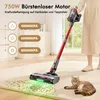 A person is using a cordless vacuum cleaner on a carpeted floor, with a cat lying nearby. The vacuum is shown cleaning up small green particles. Produktbild-Vorschau
