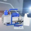 A vacuum pump with a bottle and manual on a gray and white surface with a blurred background. Náhľad obrázku produktu