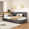 A bedroom scene featuring a gray upholstered daybed with integrated LED lighting and USB charging ports. Decorative wall art is visible on the wall behind the bed. Produktbild-Vorschau