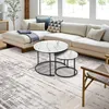 A modern living room with a sectional sofa, coffee tables, and a rug. Produktbild-Vorschau