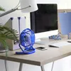 A desk scene with a computer, fan, keyboard, and phone. Náhled obrázku produktu
