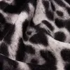 A close-up view of a fabric with a leopard print pattern. Produktbild-Vorschau