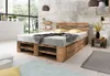 A bedroom scene featuring a wooden pallet bed with storage drawers, set against a textured wall and large windows. Produktbild-Vorschau