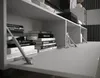 A close-up view of books stacked on a shelf within a modern furniture unit. Produktbild-Vorschau