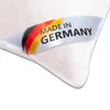 A close-up of a white pillow with a label indicating it is made in Germany. Produktbild-Vorschau
