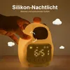 A hand is shown touching a cute, glowing capybara-shaped alarm clock with a digital display. Produktbild-Vorschau