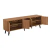 A long, low wooden cabinet with multiple open doors and shelves, standing on four black legs against a white background. Produktbild-Vorschau