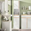 A modern bathroom with a green tiled wall, featuring a white vanity with a sink, a tall white cabinet with wood accents, and a smaller white cabinet. Anteprima dell’immagine prodotto
