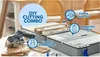 A Dremel cordless saw and cutting station are displayed on a table with wood planks. Produktbild-Vorschau