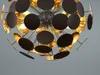 A close-up view of a modern chandelier with many circular discs. Podgląd zdjęcia produktu