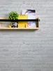 A shelf with decorative items on a brick wall. Náhled obrázku produktu