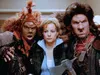 Three characters from a fantasy movie are shown, with a woman in the center being flanked by two monstrous figures. Produktbild-Vorschau