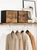 Two storage boxes with a wood-grain pattern sit on a shelf above a rack of hanging clothes. Produktbild-Vorschau