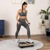 A woman is exercising on a vibration plate with resistance bands in a room. Náhled obrázku produktu