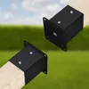 Two black metal post brackets attached to wooden posts, set against a blurred background of green grass and a blue sky. Anteprima dell’immagine prodotto