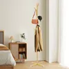 A bedroom scene with a coat rack, bed, and nightstand. Produktbild-Vorschau