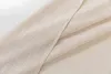 A close-up view of beige fabric with a linen-like texture, folded to show its weave and drape. Produktbild-Vorschau
