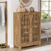 A wooden shoe cabinet with slatted doors is shown in a room with a coat rack and a window. Anteprima dell’immagine prodotto