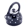 A black kettle with white polka dots and a silver lid and spout. Produktbild-Vorschau