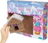 A hand is shown placing a gingerbread house into an open advent calendar. Podgląd zdjęcia produktu