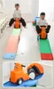 Two children are playing on a toy slide with toy cars. Voir les images du produit