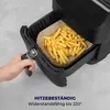 A hand is shown pulling out the basket of an air fryer filled with french fries. Podgląd zdjęcia produktu