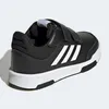 A black Adidas sneaker with white stripes and velcro straps, shown from the side and back. Podgląd zdjęcia produktu
